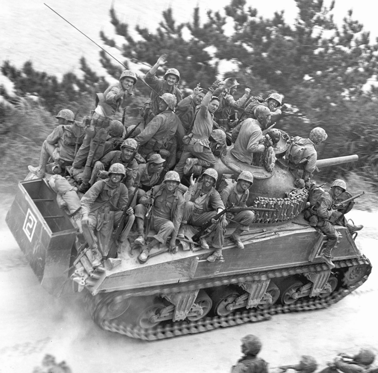 April 1, 1945 Riflemen of the 29th Marine Regiment Ride a M4A3 Sherman 105mm of Company A, 6th Tank Battalion During the 6th Marine Division Drive on Chuda, Okinawa